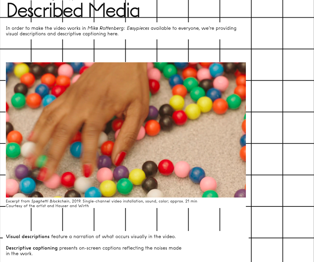 Screenshot of webpage titled Described Media featuring a still of a hand playing with marbles